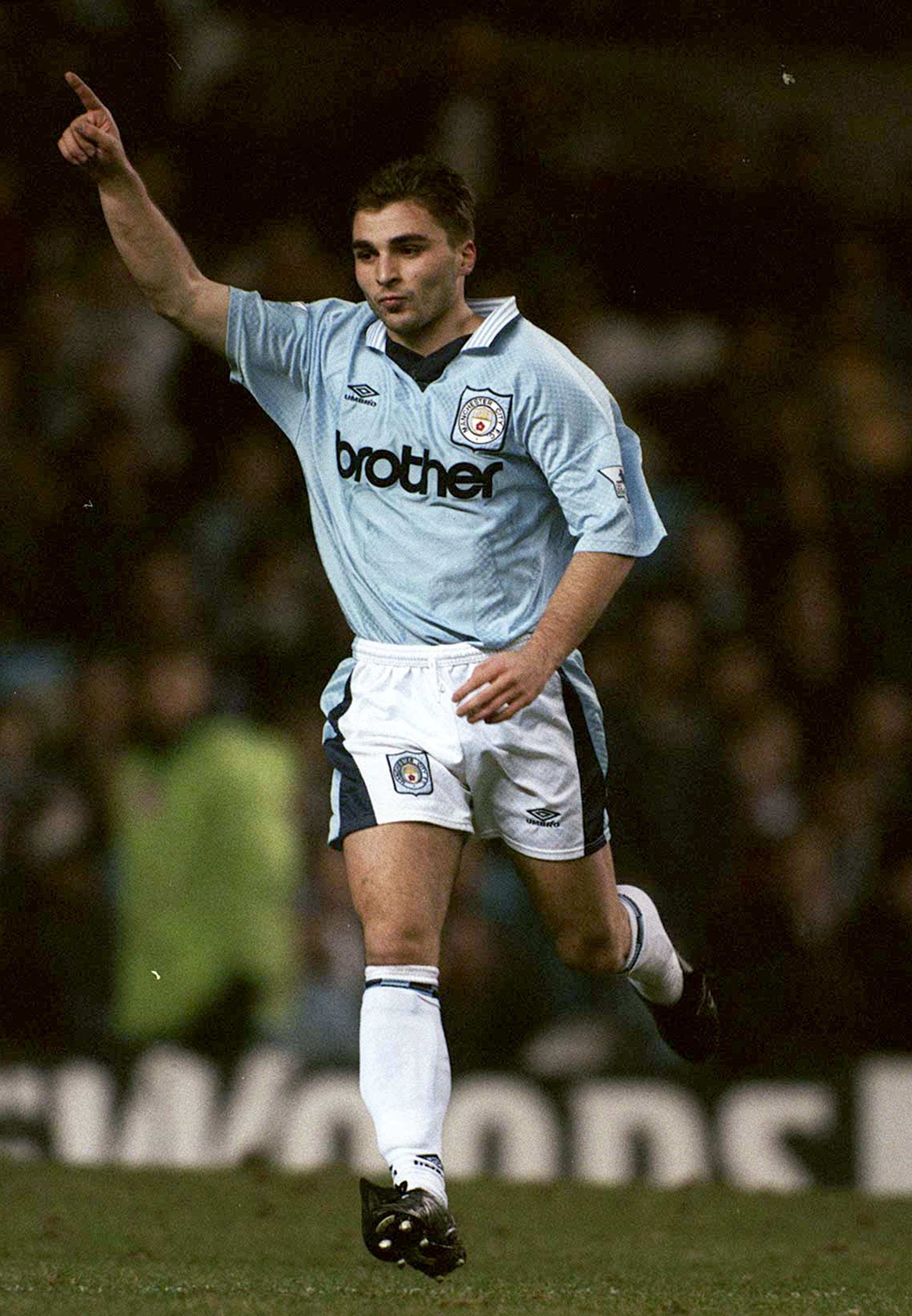 Kinkladze wheeling away with one arm raised after scoring